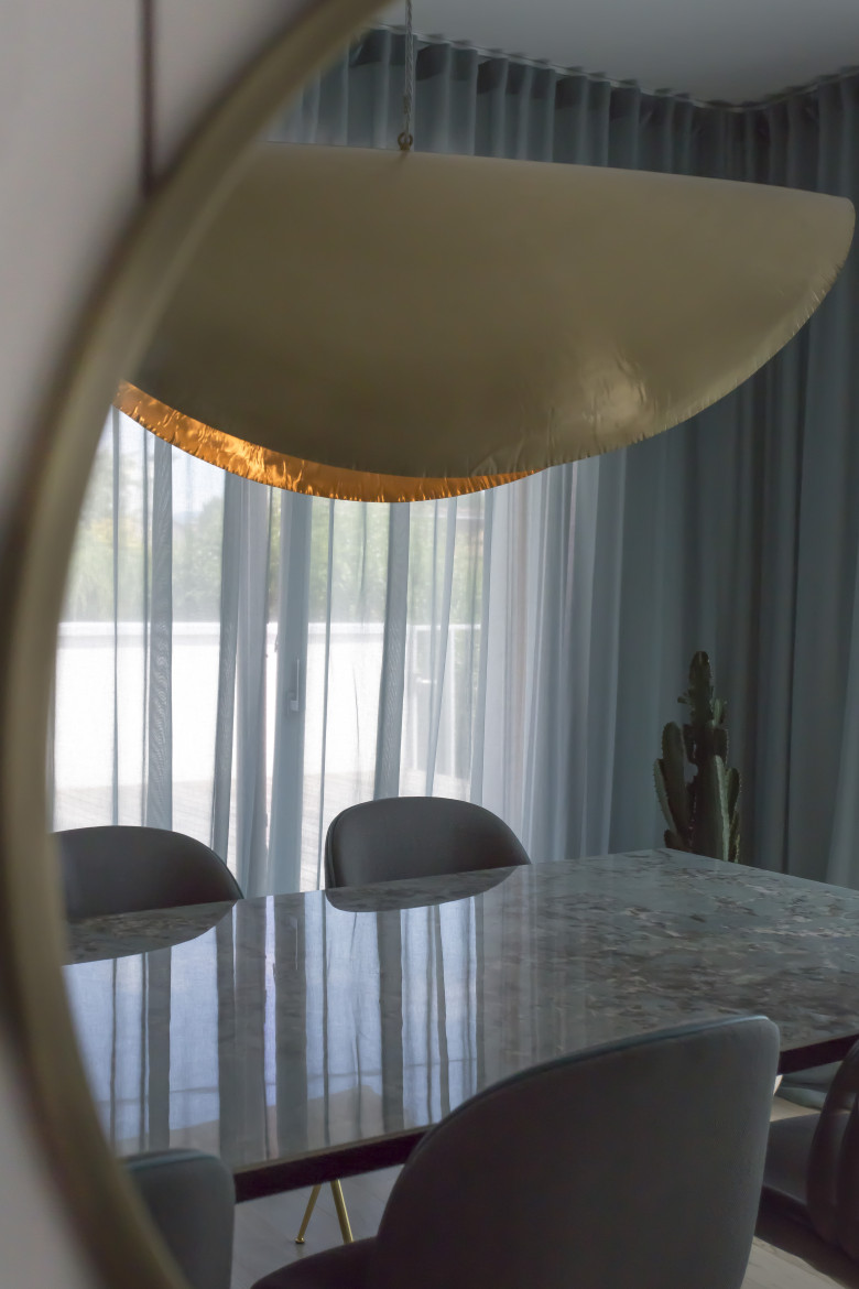 crown-reflection-brass-mirror-and-dining-area